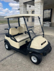 A golf cart parked in front of a building.