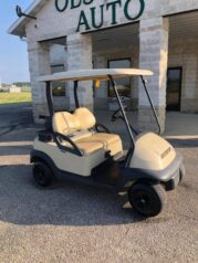 A golf cart parked in front of a building.