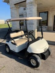 A golf cart parked in front of a building.